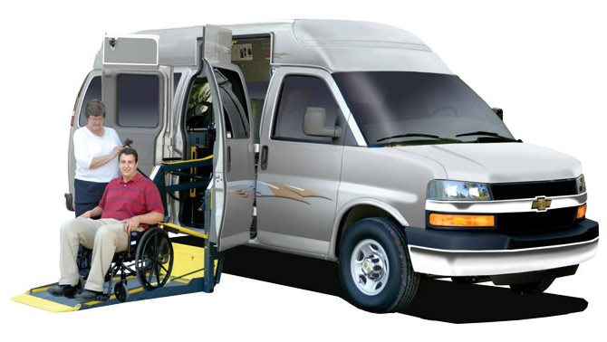 Adaptavan with wheelchair lift depoloyed.  The wheelchair van is red.